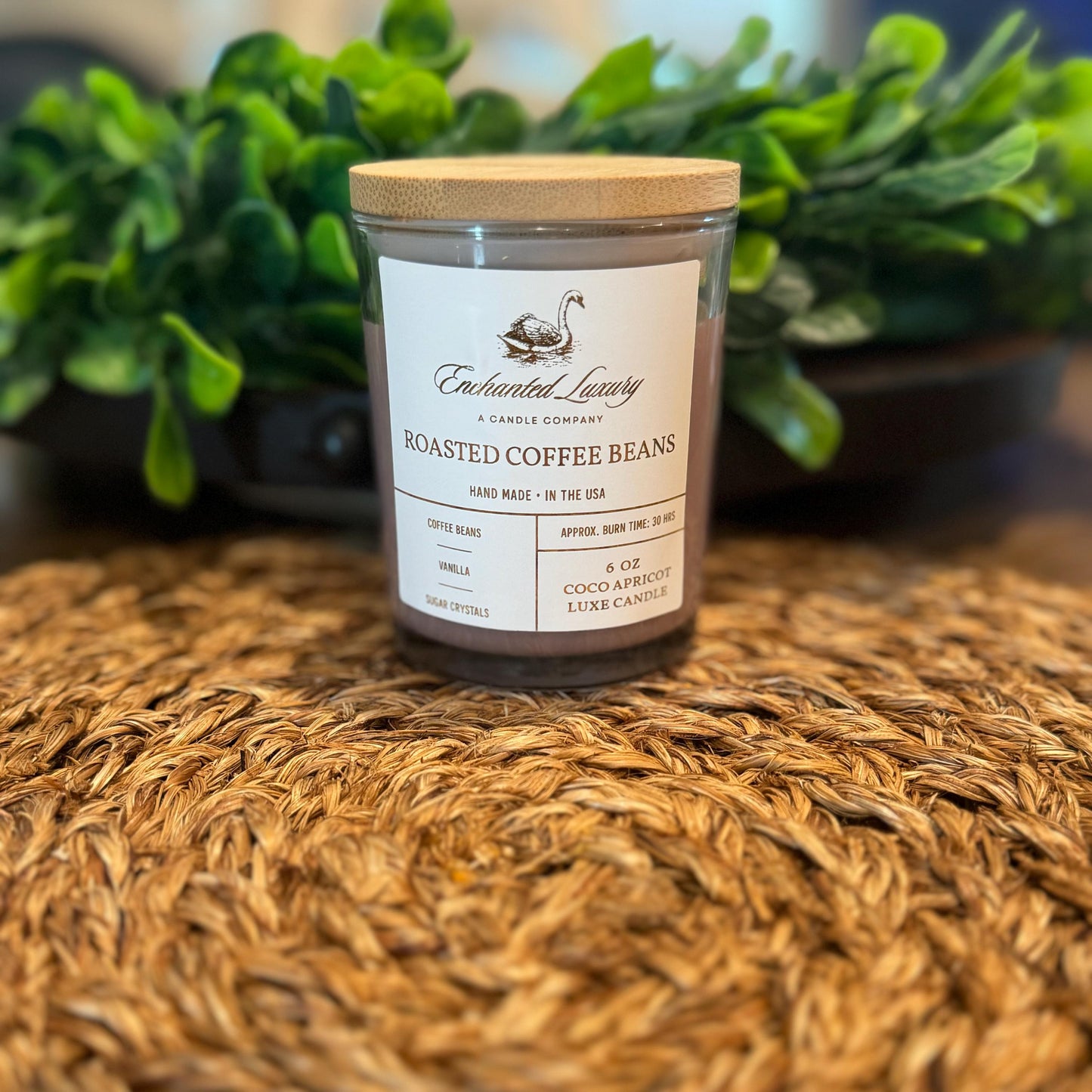 a candle sitting on top of a table next to a potted plant
