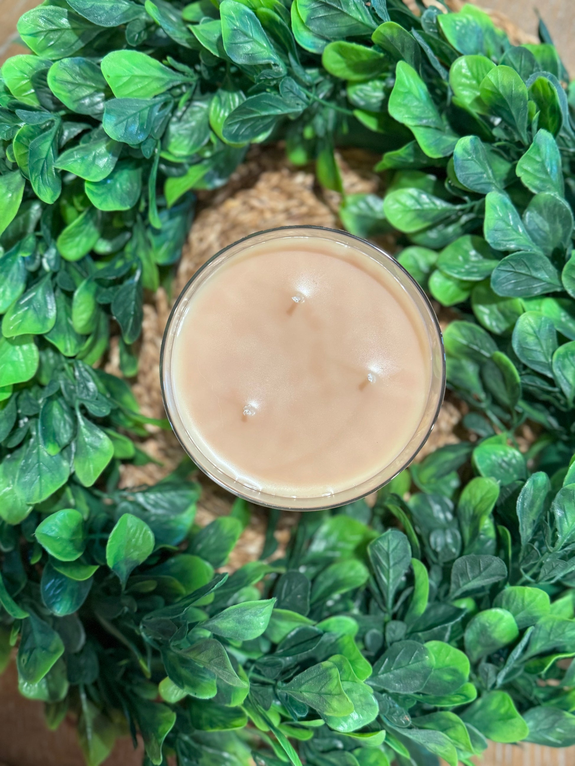 a candle sitting on top of a green wreath