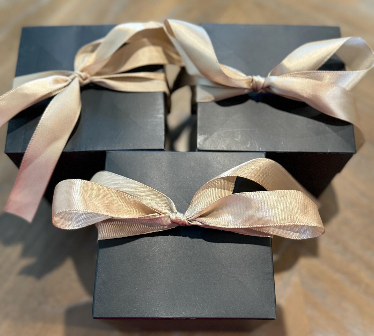 a black box with a gold ribbon tied around it