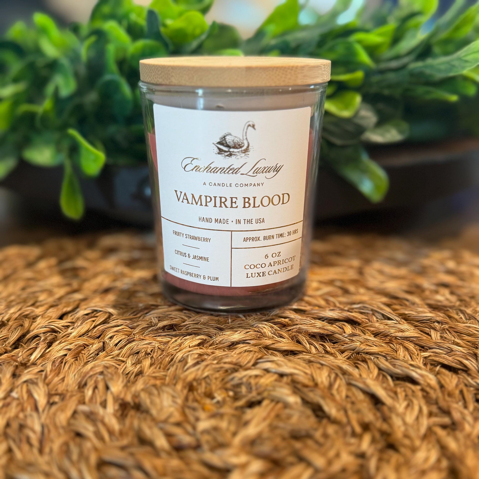 a candle sitting on top of a table next to a potted plant