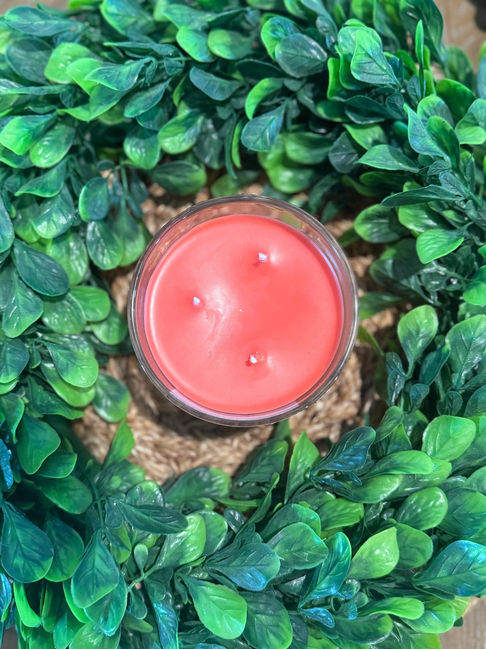 a candle sitting on top of a green wreath